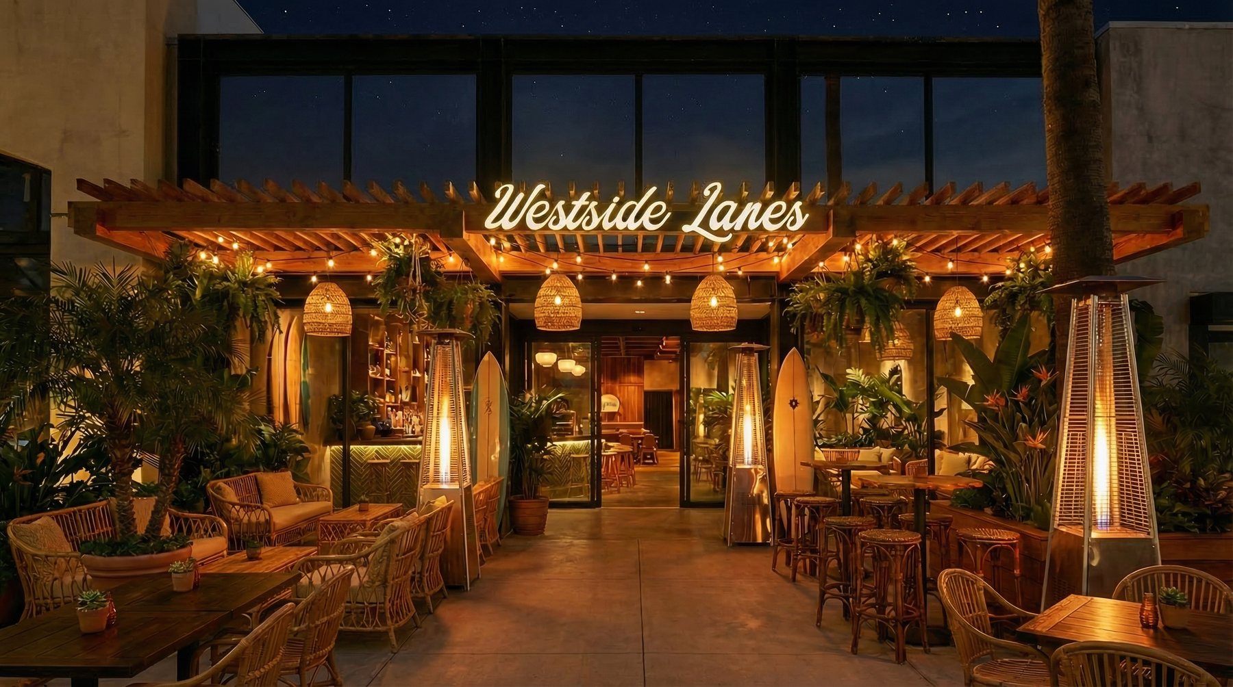 The warmly-lit Westside Lanes storefront at dusk with a neon sign